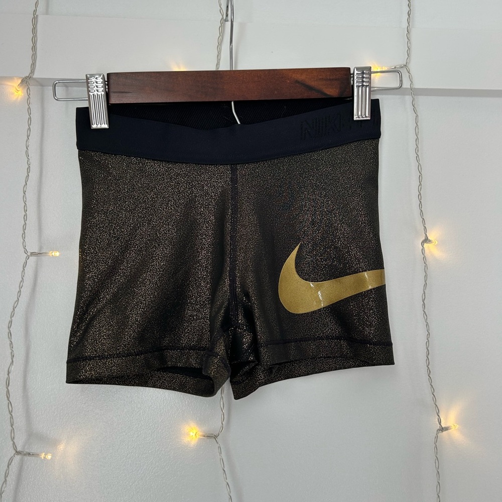 Nike black and gold shorts with a gold nike check